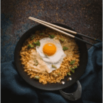 Tom Yum Noodles, fried Egg (Thai) <br> نودلز توم يام، بيض مقلي (تايلاندي)